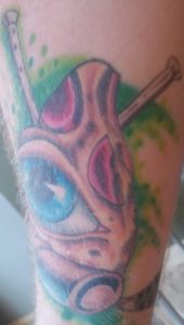 Pizza with Eye and Two Hockey Sticks Tattoo