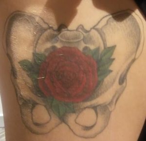Pelvis tattoo with rose in it