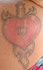 Dagger through a heart tattoo