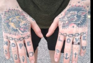 Lion wolf hand Hope Love tattoos Left hand finger symbols: umbrella, anchor, cross, diamond Right hand finger symbols: tear drop, key hole, lighting bolt, coffee cup.