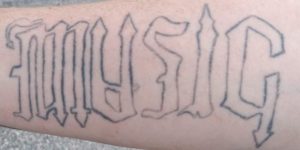 Ambigram music breath tattoo