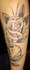 Skull with a rose tattoo
